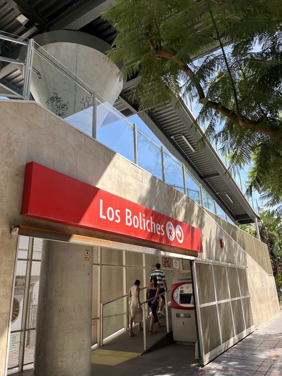 Los Boliches Train Station — entrance with red sign